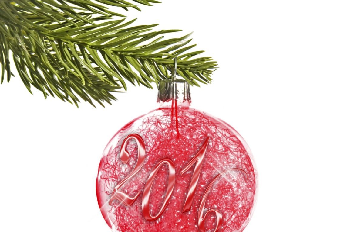 2016 on a red christmas ball hanging from a branch isolated on white