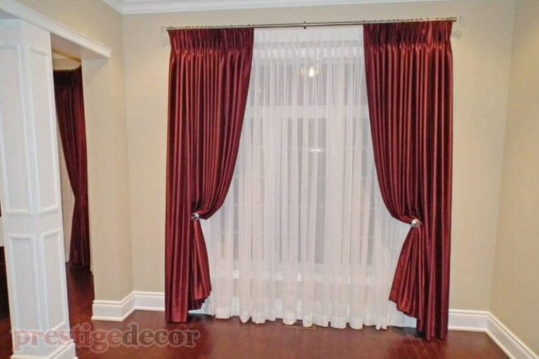 Elegant curtains with sheers on an iron curtain rod with crystal finials and matching holdbacks