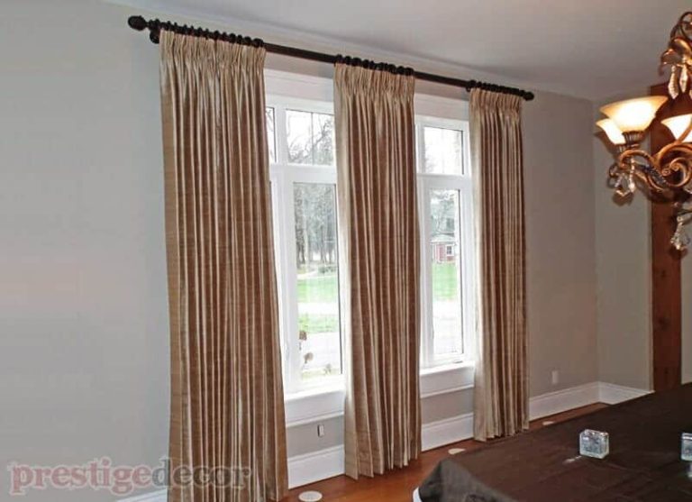 Elegant curtain panels on a rich wooden rod with wooden finials