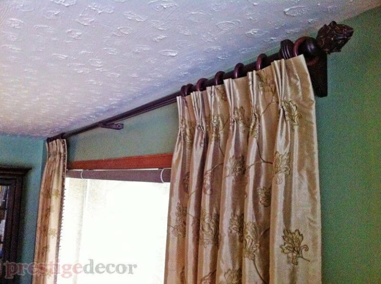 Elegant curtain panels on a wooden curtain rod with wooden finials