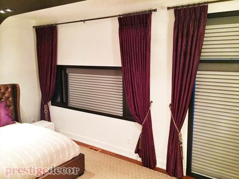 Purple curtains with remote control blinds in the master bedroom.