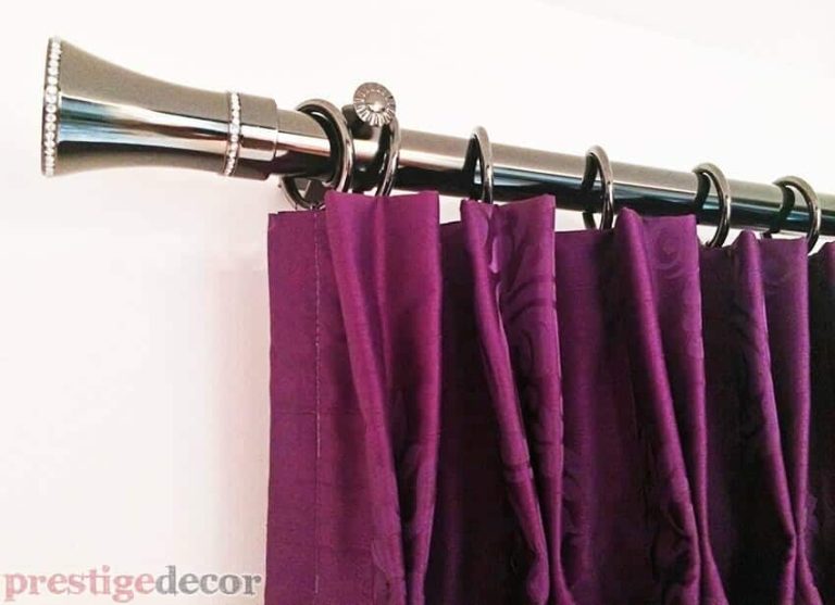 Stunning purple curtains with gorgeous iron drapery hardware.