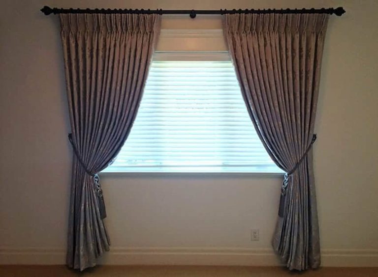 Beautiful draperies with blinds in a bedroom in Oakville