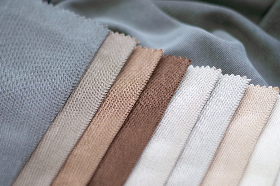 The color palette of fabric for curtains. Velvet fabric in milky, gray and brown colors