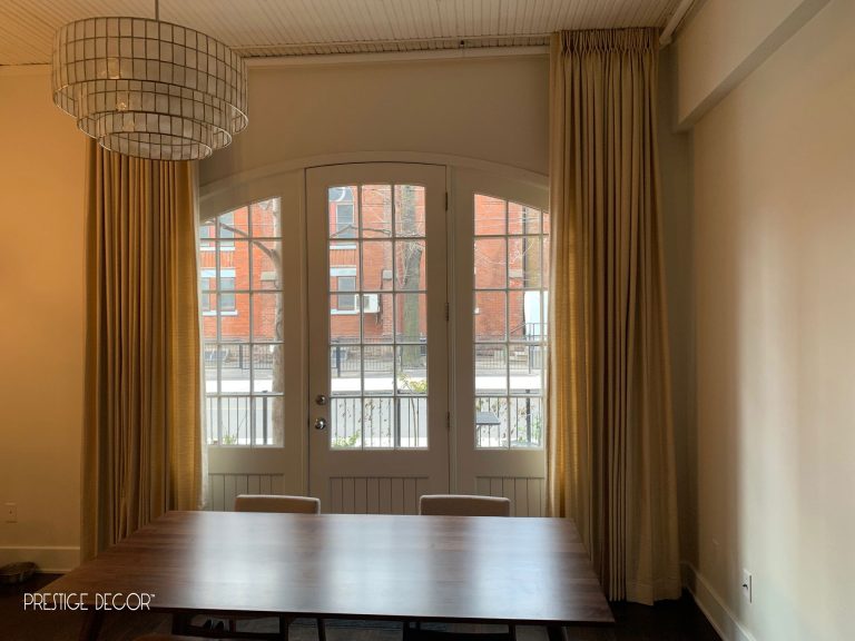 Industrial look townhouse in downtown Toronto with ceiling mounted custom living room draperies on a curtain track. Client wanted to hide the pipes and chose an unlined linen polyester fabric. Curtains in open position