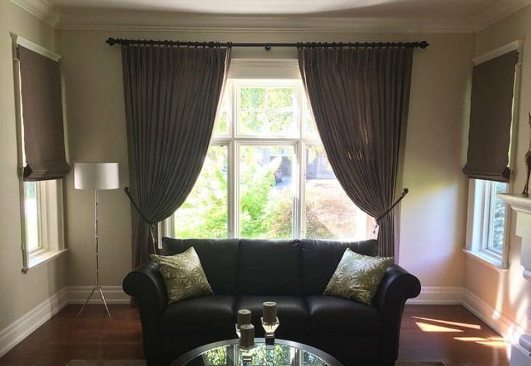 Brown pattern curtains with tiebacks and roman blinds in an Oakville villa