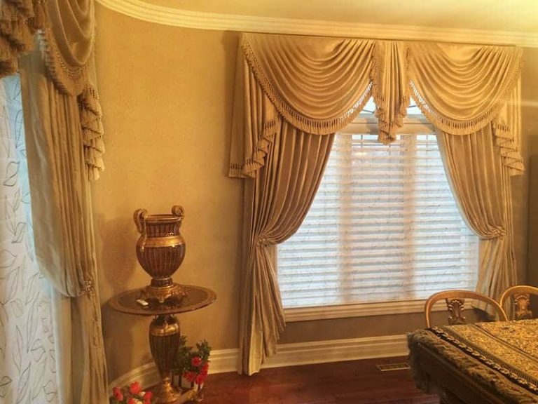 Luxurious window treatments with swags, side panels, shades, and Swarovski crystal holdbacks