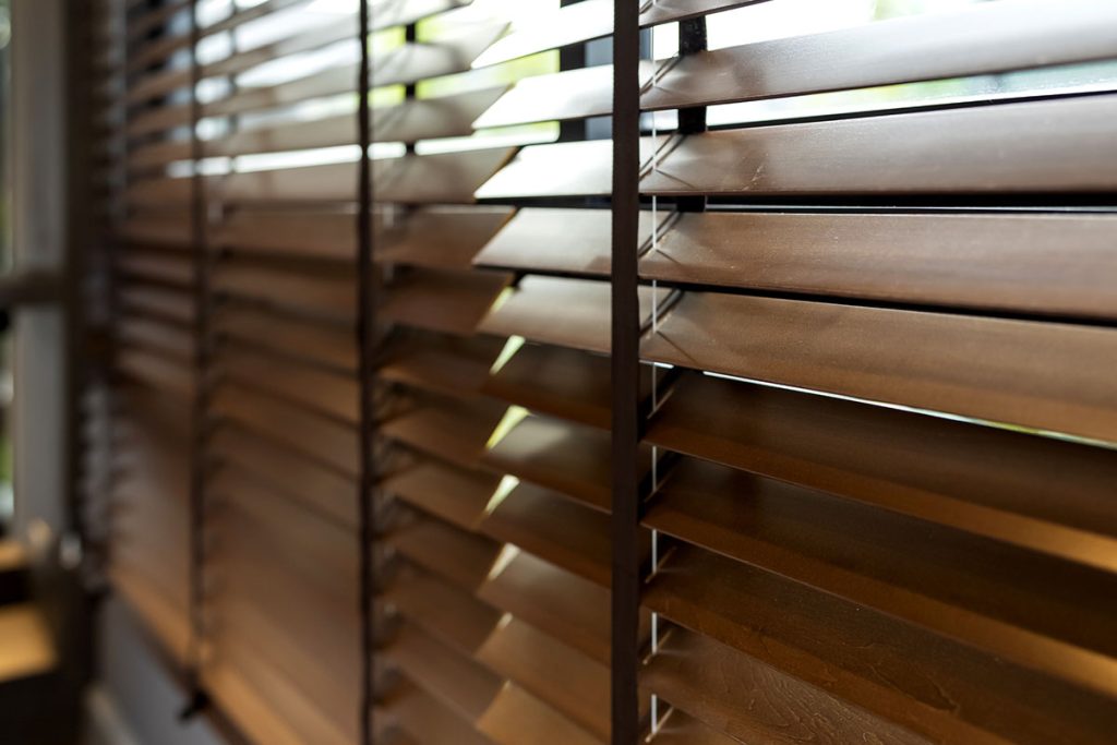 wooden window shutter blind with light from sun home interior concept